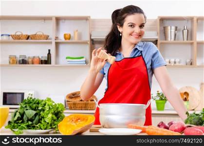 The young woman with vegetables in the kitchen. Young woman with vegetables in the kitchen