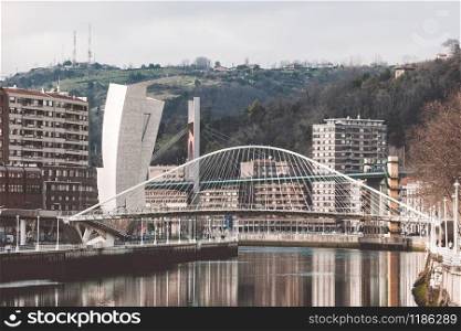 The Zubizuri, the Campo Volantin Footbridge in Bilbao, Spain, modern pedestrian tied arch crossing of the Nervion River by Santiago Calatrava architect