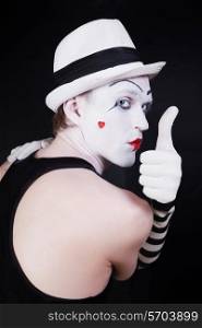 Theater actor with mime makeup on a black background