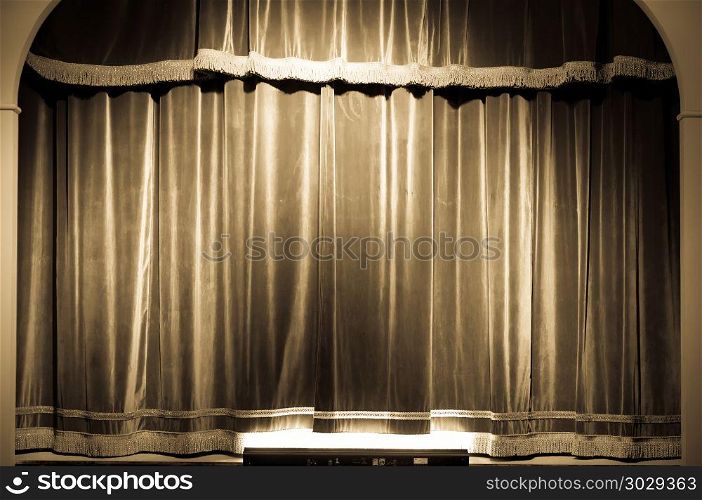 Theatre curtain on stage. A red curtain in an old and very small Italian theatre.