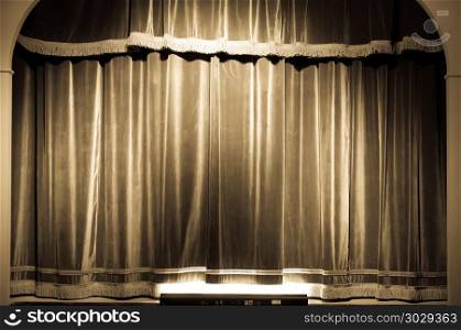 Theatre curtain on stage. A red curtain in an old and very small Italian theatre.