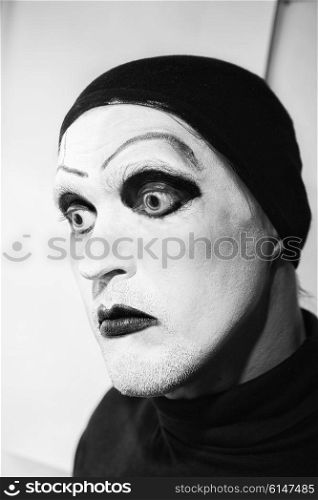 Theatrical actor with dark makeup on her face close up