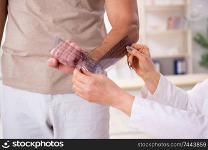 Thefemale doctor checking patient&rsquo;s joint flexibility with goniometer. Female doctor checking patient&rsquo;s joint flexibility with goniometer