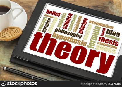 theory word cloud on a digital tablet with a cup of coffee