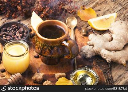 therapeutic tea with ginger. cup with therapeutic tea from the root of ginger, honey and lemon