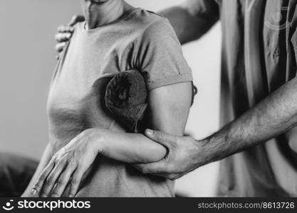 Therapist Checking Senior Woman’s Shoulder