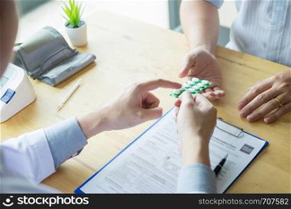 therapist consulting to patient male patient about pills writing his medical prescription drug in the office