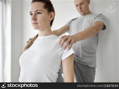 therapist undergoing physical therapy with female patient 3