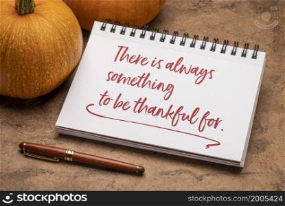 There is always something to be grateful for - handwriting in a spiral sketchbook with a pumpkin, Thanksgiving holiday inspirational concept