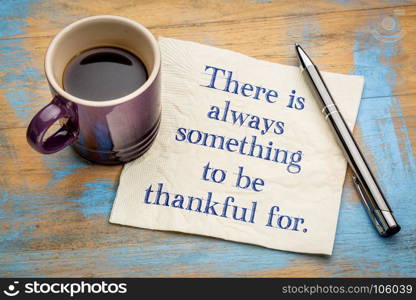 There is always something to be thankful for. - handwriting on a napkin with a cup of espresso coffee