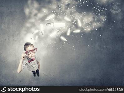 There is great idea in my mind. Wideangle picture of funny schoolboy with paper plane in hand