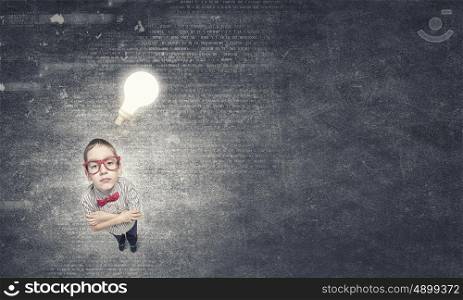 There is great idea in my mind. Wideangle picture of funny schoolboy with paper plane in hand