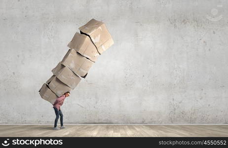 There is never too much shopping. Young girl in casual carrying stack of carton boxes