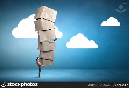 There is never too much shopping. Young girl in casual carrying stack of carton boxes