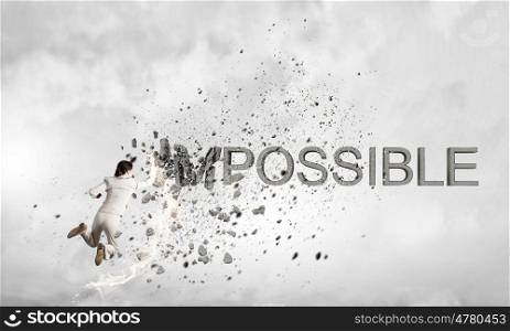 There is nothing impossible. Young emotional woman crashing word impossible with hand punch