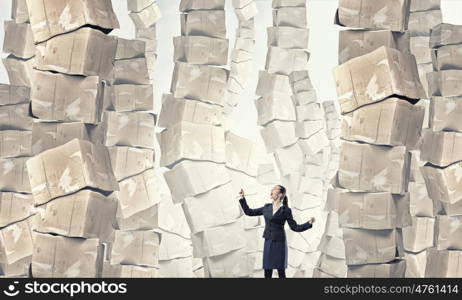 There is so much to do. Businesswoman screaming among pile of carton boxes