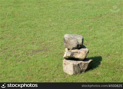 There were tree stones on a grassland.