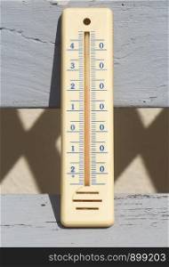 Thermometer on a wooden bench in a garden