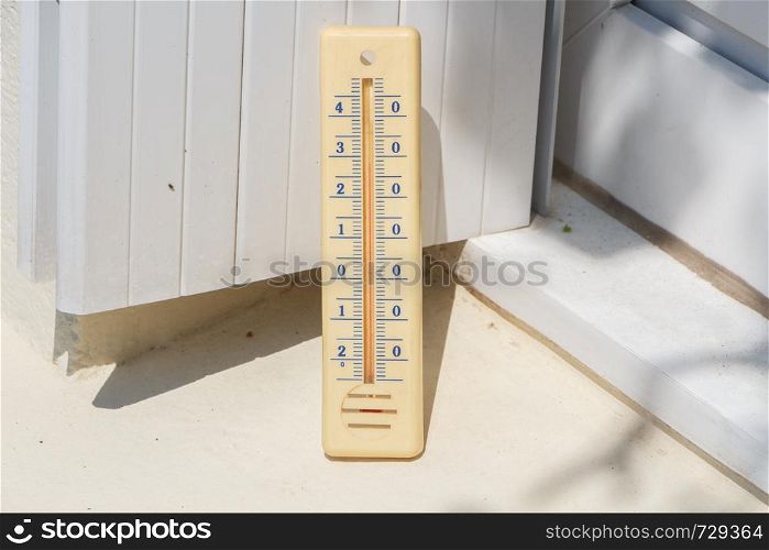 Thermometer on the edge of a window during summer