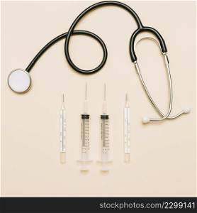 thermometers syringes near stethoscope