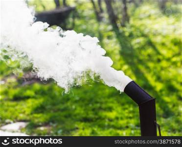 thick smoke from the chimney of a samovar outdoors