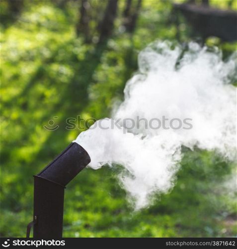 thick smoke from the pipe of a samovar outdoors