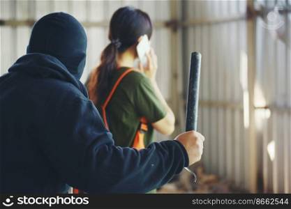 Thief armed man rob woman by baton on street stalker behind young woman back. Woman on phone careless stalker sneaking to steal, rob aggressive by danger bandit. Thief using baton nightstick weapon.