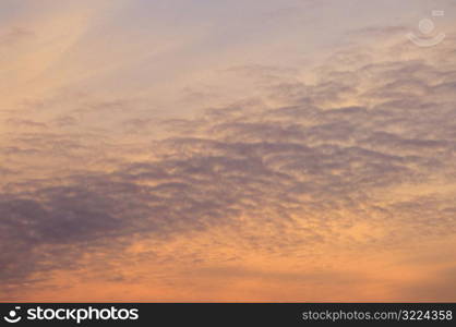 Thin Clouds In An Orange And Purple Sky
