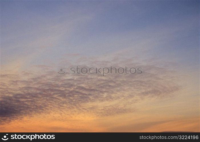 Thin Clouds In An Orange And Purple Sunset Sky