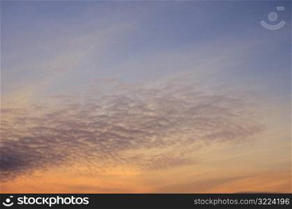 Thin Clouds In An Orange And Purple Sunset Sky