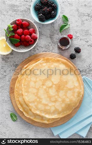 Thin crepes with fresh berries and lemon zest. Pancakes with raspberry and blackberry.