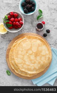 Thin crepes with fresh berries and lemon zest. Pancakes with raspberry and blackberry.