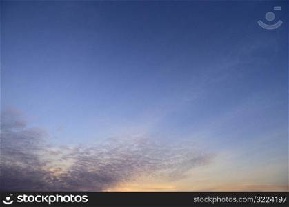 Thin Purple Clouds In A Blue And Orange Sunset Sky
