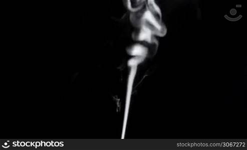 Thin smoke on a black background.