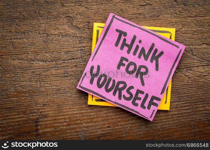 Think for yourself reminder or advice - handwriting on a sticky note against rustic wood