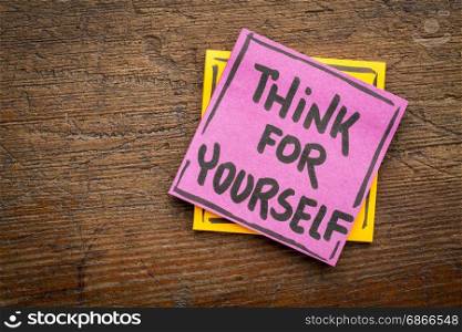 Think for yourself reminder or advice - handwriting on a sticky note against rustic wood