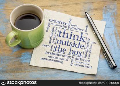 Think outside the box concept - word cloud on a napkin with a cup of coffee