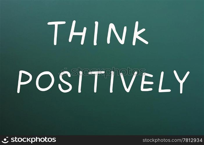 Think positively written with white chalk on a blackboard background