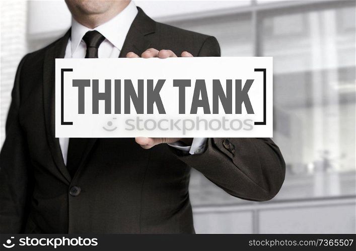 Think tank sign is held by businessman.. Think tank sign is held by businessman