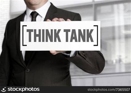 Think tank sign is held by businessman.. Think tank sign is held by businessman