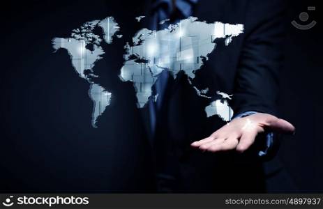 Think wide and global. Close view of businessman showing world map in palm