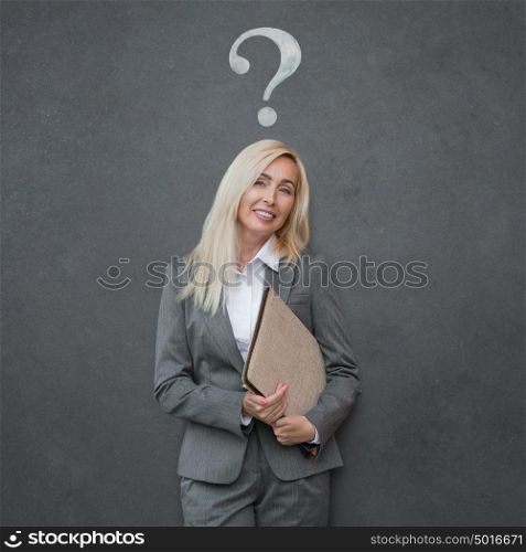 Thinking business woman looking up on question mark on gray background