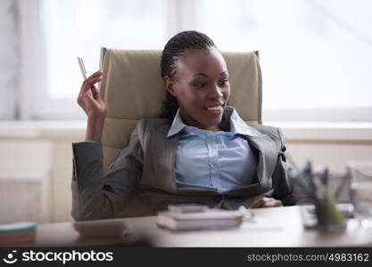 Thinking businesswoman in suit sitting at workplace and working hard with laptop