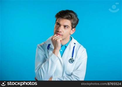 Thinking doctor man looking up and around on blue background. Worried contemplative face expressions. Handsome doc in medical coat with stethoscope. High quality photo. Thinking doctor man looking up and around on blue background. Worried contemplative face expressions. Handsome doc in medical coat with stethoscope