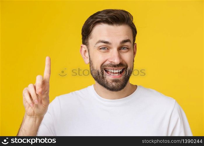 Thinking man isolated on yellow background. Closeup portrait of a casual young man finger up at copyspace. Caucasian male model. Thinking man isolated on yellow background. Closeup portrait of a casual young man finger up at copyspace. Caucasian male model.