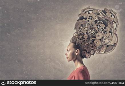 Thinking mechanisms. Thinking businesswoman with gear mechanisms on her head
