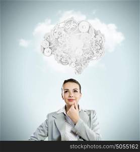 Thinking mechanisms. Thinking businesswoman with gear mechanisms on her head