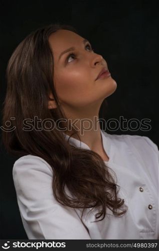 Thinking medical doctor woman looking up contemplative and thoughtful