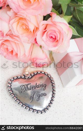 Thinking of You Heart with pink roses on white table. Heart with pink roses