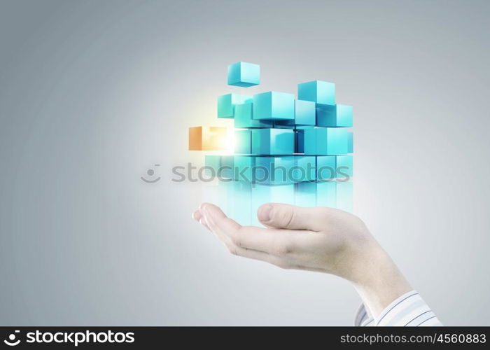 Thinking outside the box as concept. Businessman hand shows cube as symbol of problem solving